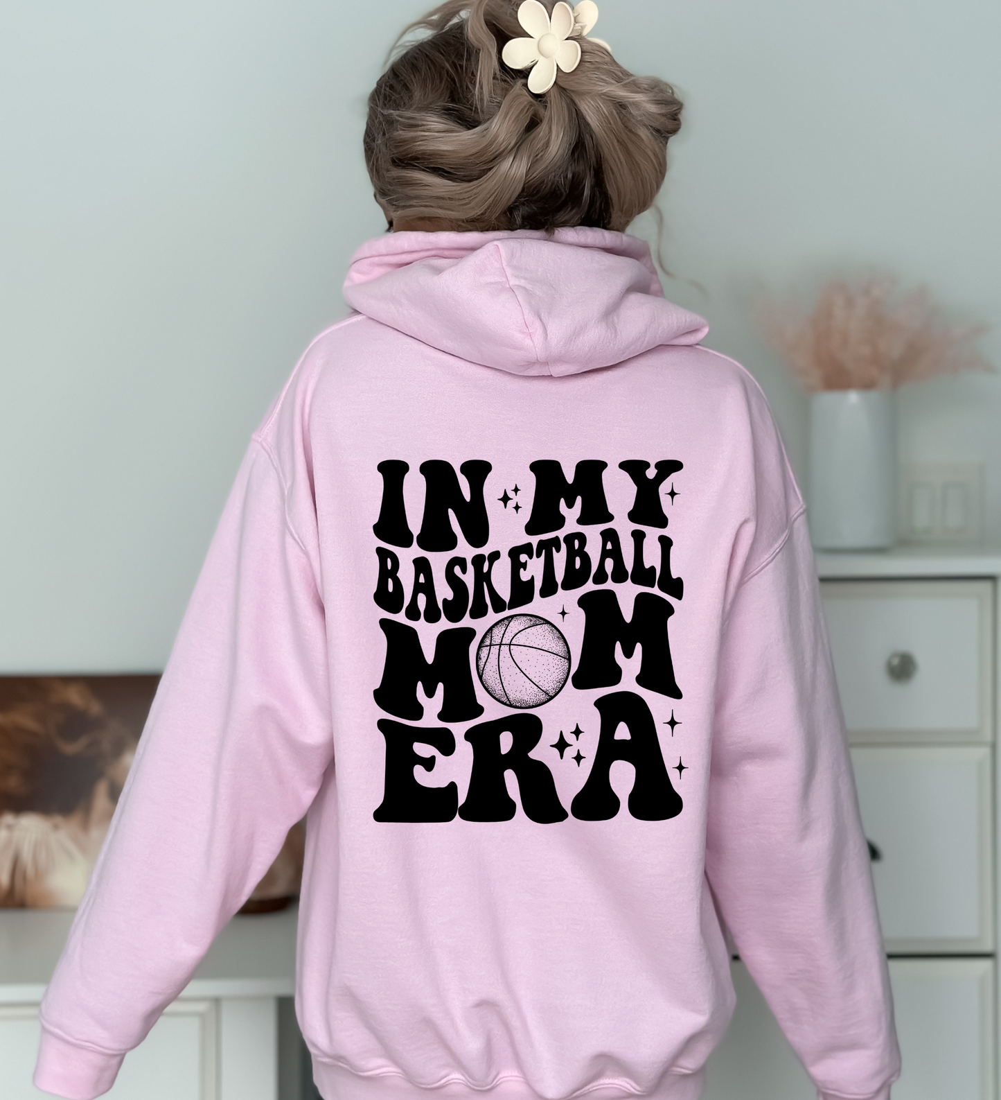 A cozy oversized hoodie for basketball mamas with the text 'In My Basketball Mom Era'. This sweatshirt is ideal for game day, offering comfort and style for basketball moms supporting their players.