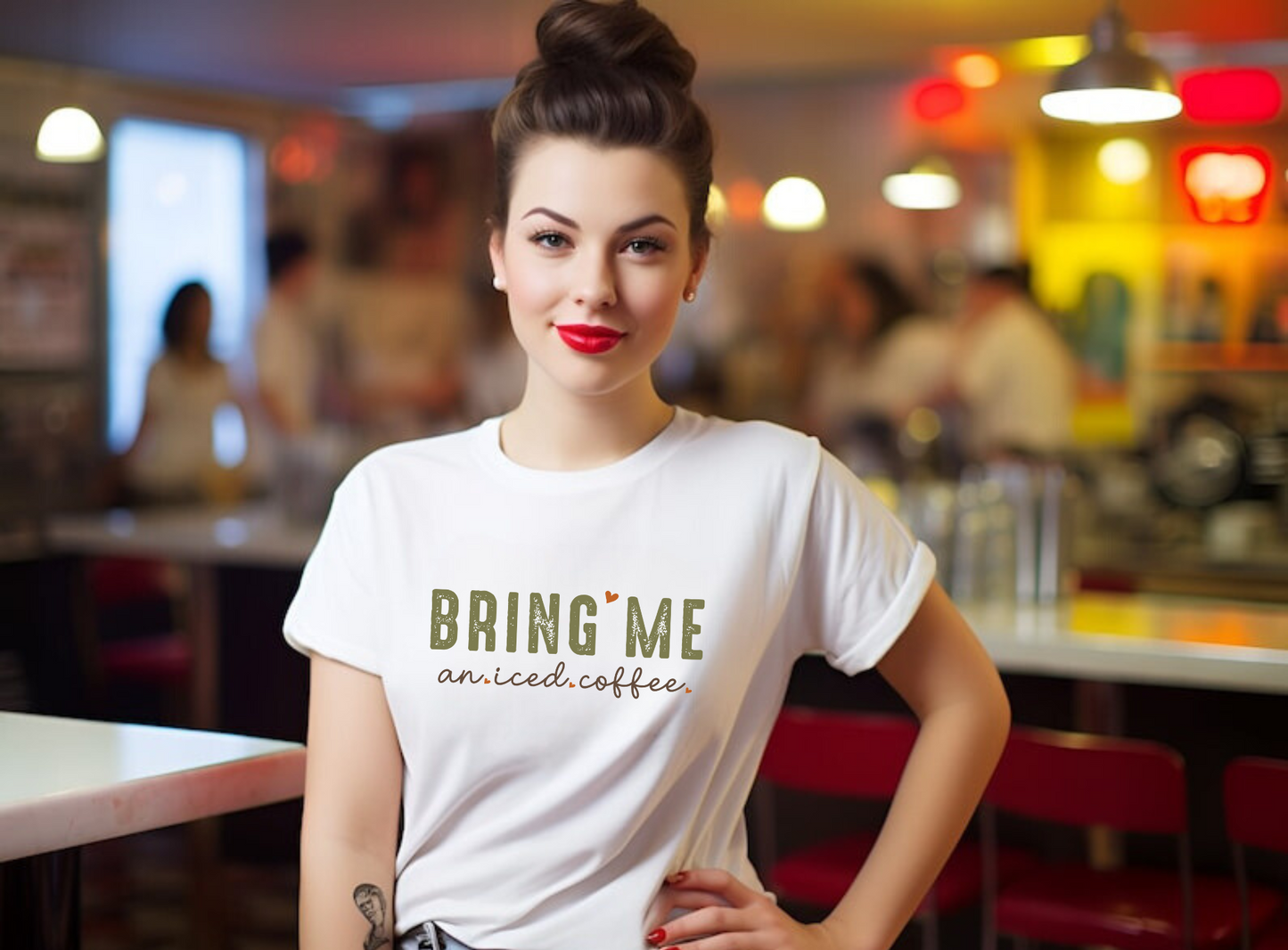 A close-up image of a women's coffee shirt with the text "Bring Me an Iced Coffee" printed on it. The shirt is displayed on a white background and features a stylish and humorous design. Perfect for coffee lovers and summer outfits.