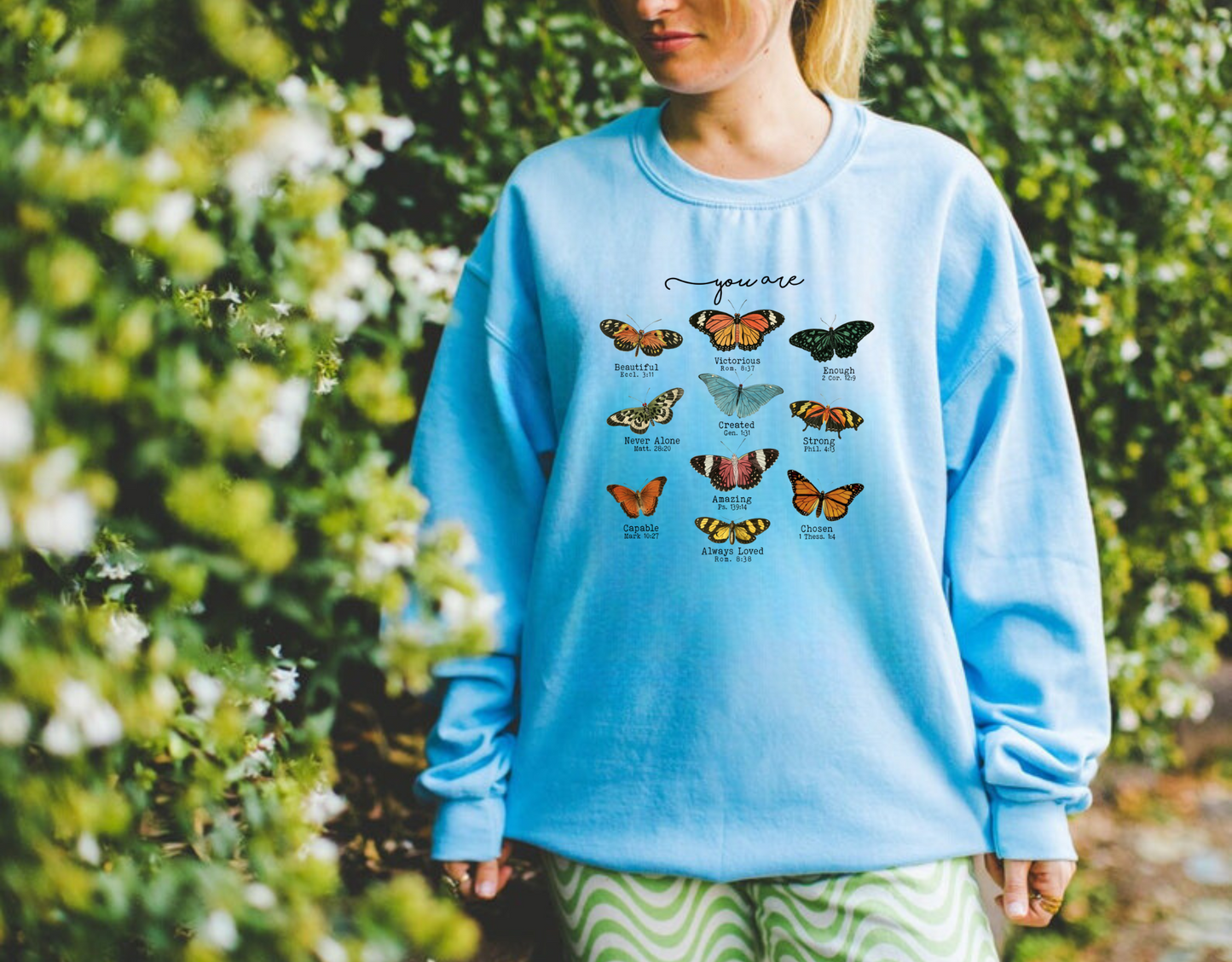 Christian crewneck sweatshirt with butterfly designs and Bible verse quotes.