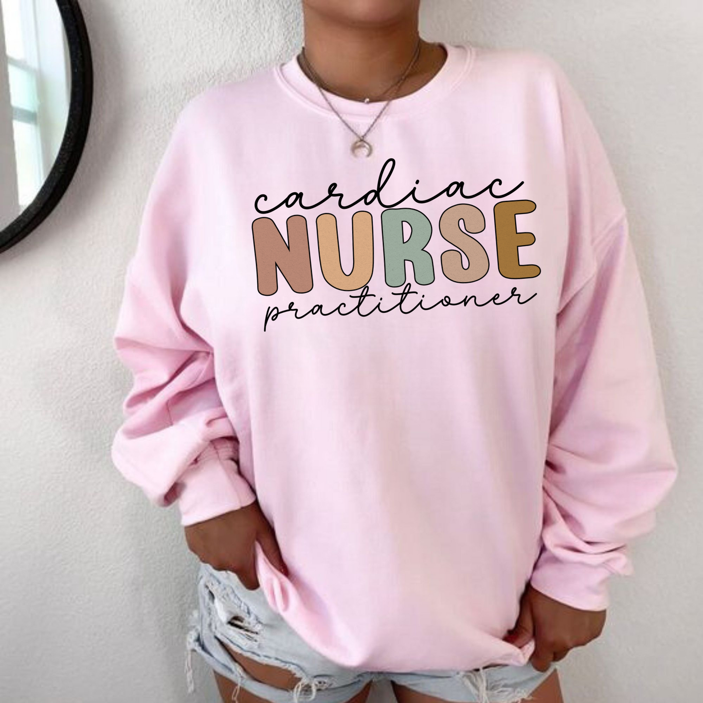 A Cardiac Nurse Practitioner Crewneck Sweatshirt, featuring a stylish and comfortable design. This nurse sweater is tailored for cardiac nurses and nurse practitioners, making it the perfect addition to your nurse work outfit. Showcase your expertise and dedication in cardiac care with this cute nurse sweatshirt. Shop now and elevate your nurse clothes collection with this specialized nurse practitioner apparel.