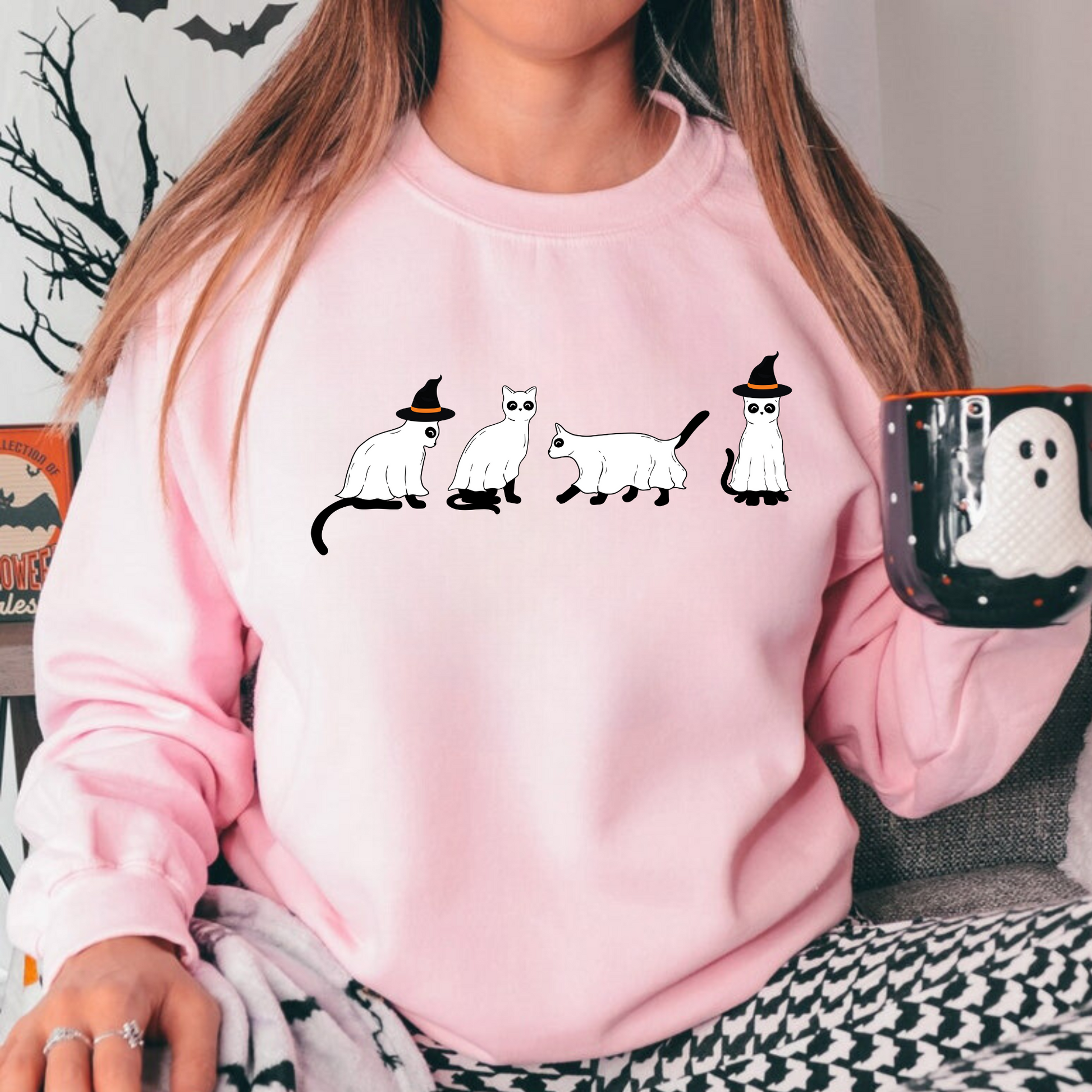 A stylish oversized sweatshirt with a cute and spooky ghost cat design, perfect for Halloween and cat lovers. The black cat ghost adds a touch of whimsy to your fall outfit.