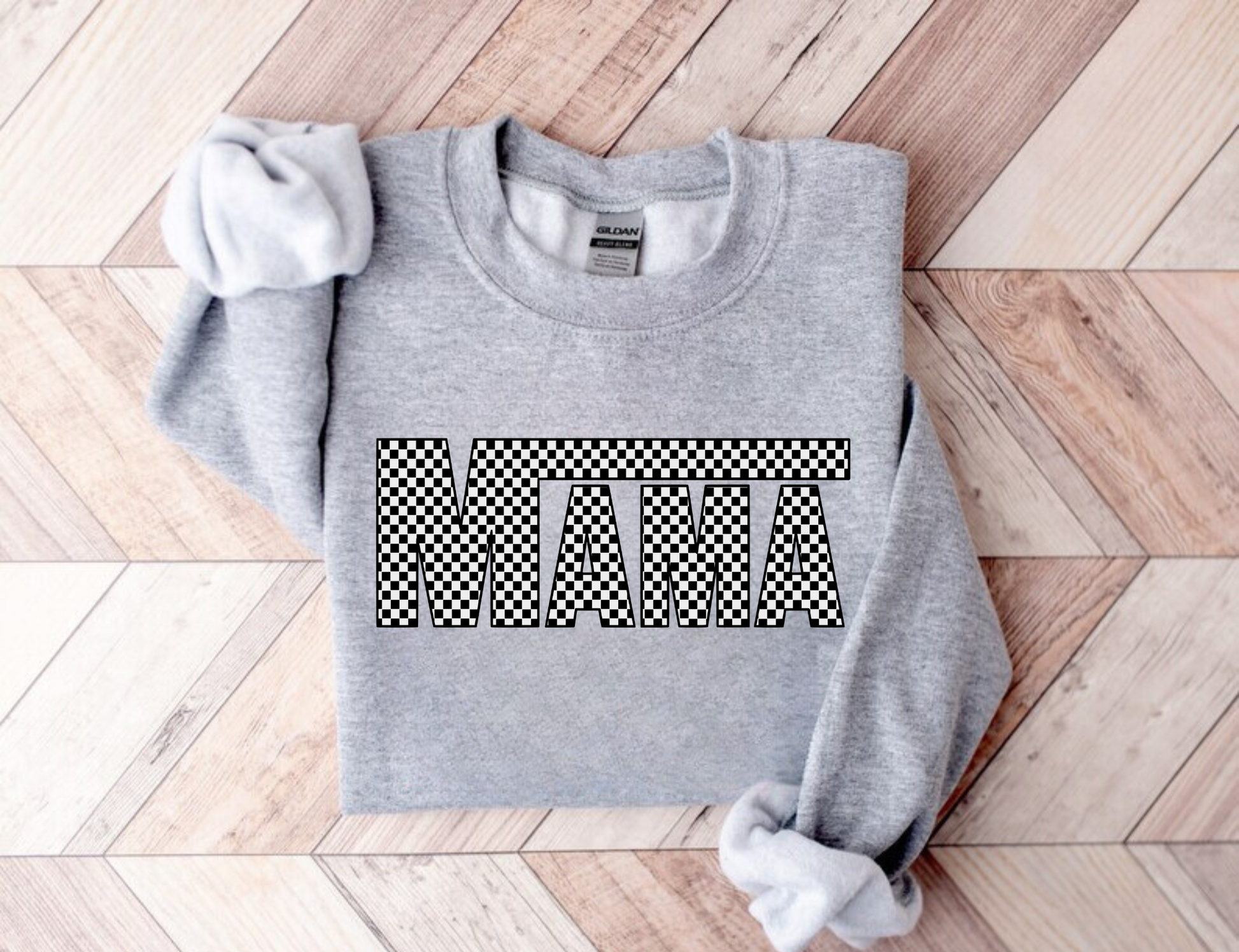 A cozy and stylish checker print mama crewneck sweatshirt. This oversized and comfy sweatshirt is perfect for moms, featuring a trendy checkerboard print design. Shop now and add this cute and cozy mama crewneck sweatshirt to your mom wardrobe.