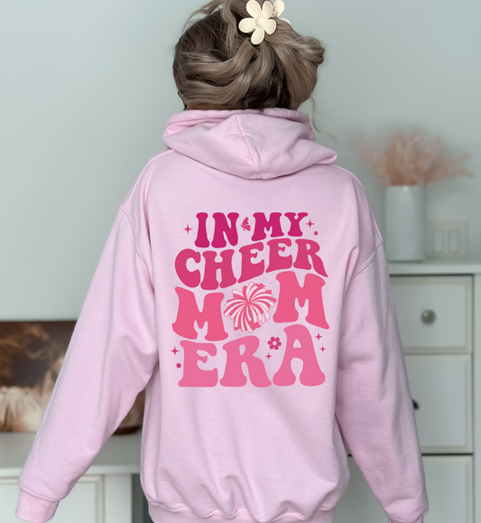 A comfortable hoodie for cheer moms with the text 'In My Cheer Mom Era'. This sweatshirt is ideal for showcasing support for cheerleaders, offering a mix of comfort and style in a humorous design.