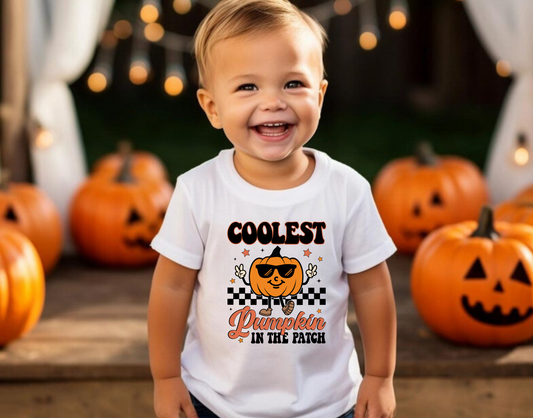 An adorable Halloween shirt for boys with the phrase 'Coolest Pumpkin In The Patch', featuring a preppy and playful design. The shirt adds a unique touch to his Halloween outfit, embodying the essence of cute Halloween fun.