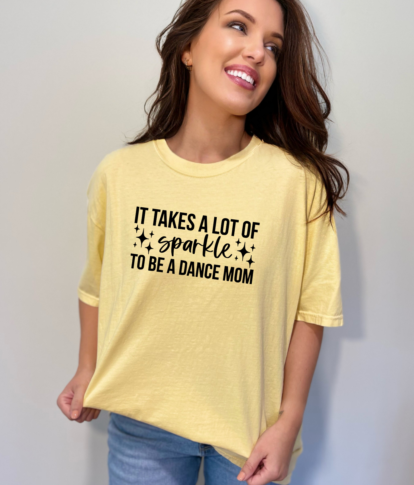 An image of a cute and stylish oversized Dance Mom shirt with a design that represents the pride and enthusiasm of being a dance competition mom. Perfect for joining the dance mom squad or club, this shirt also makes a great gift. The shirt is made of high-quality Comfort Colors fabric and is designed for comfort and style.