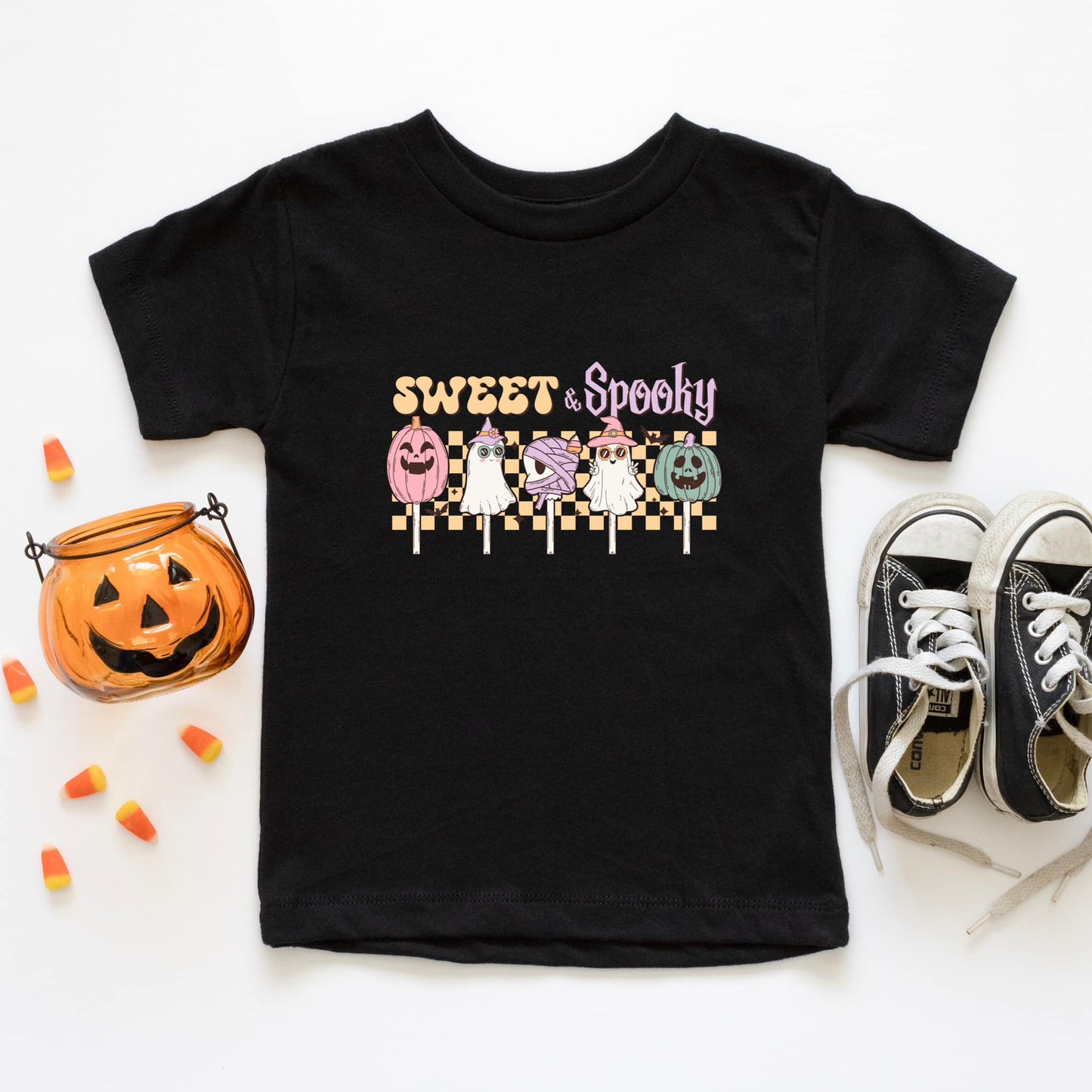 An adorable Halloween shirt for girls with the phrase ',Sweet and Spooky featuring a preppy and playful design. The shirt adds a unique touch to her Halloween outfit, embodying the essence of cute Halloween fun.