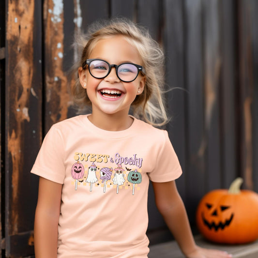 An adorable Halloween shirt for girls with the phrase ',Sweet and Spooky featuring a preppy and playful design. The shirt adds a unique touch to her Halloween outfit, embodying the essence of cute Halloween fun.