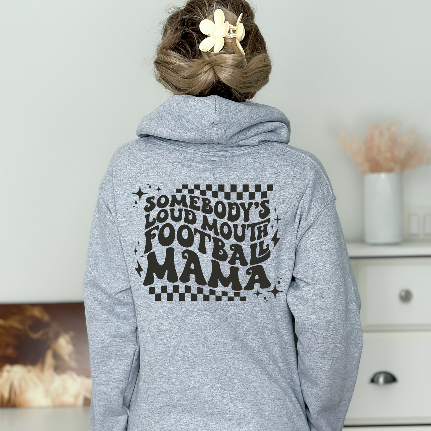 Stay cozy and comfortable while rooting for your football star with our football mom hoodie sweatshirt. Crafted for both comfort and style, this hoodie is the ultimate choice for chilly football game days. Show your support for your athlete while staying warm in this essential hoodie. Stay comfy and stylish as a proud football mama, all while enjoying the excitement of the game!