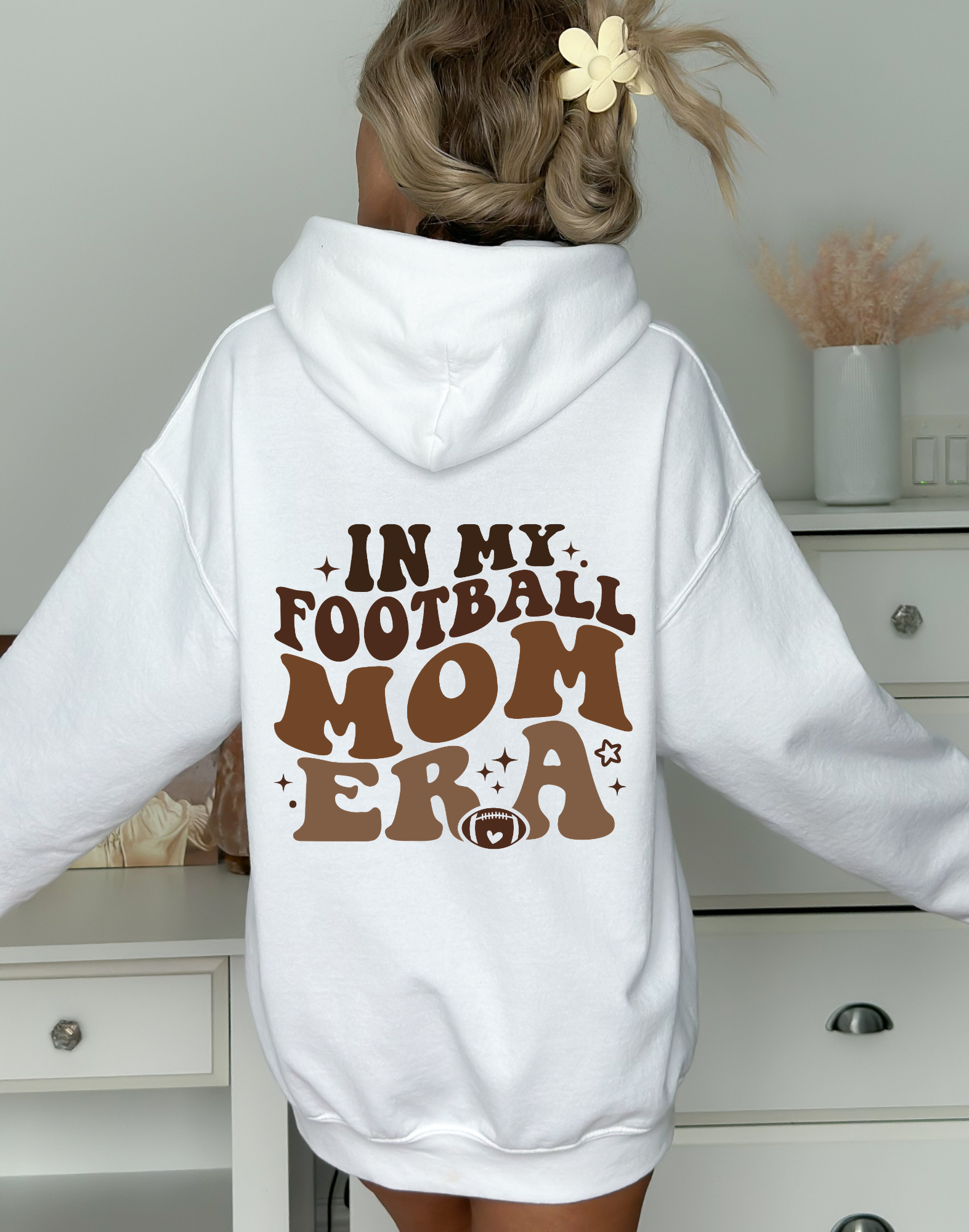 Stay cozy and comfortable while rooting for your football star with our football mom hoodie sweatshirt. Crafted for both comfort and style, this hoodie is the ultimate choice for chilly football game days. Show your support for your athlete while staying warm in this essential hoodie. Stay comfy and stylish as a proud football mama, all while enjoying the excitement of the game!