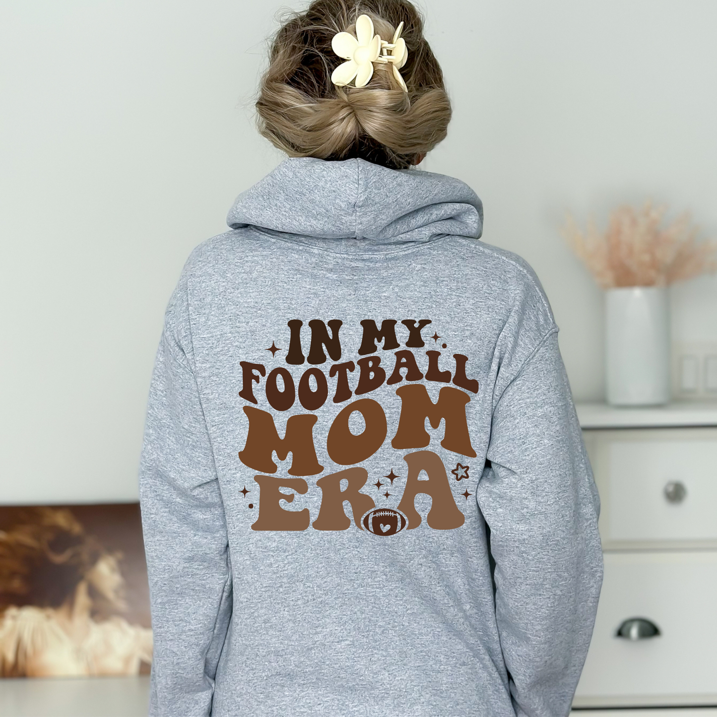 Stay cozy and comfortable while rooting for your football star with our football mom hoodie sweatshirt. Crafted for both comfort and style, this hoodie is the ultimate choice for chilly football game days. Show your support for your athlete while staying warm in this essential hoodie. Stay comfy and stylish as a proud football mama, all while enjoying the excitement of the game!