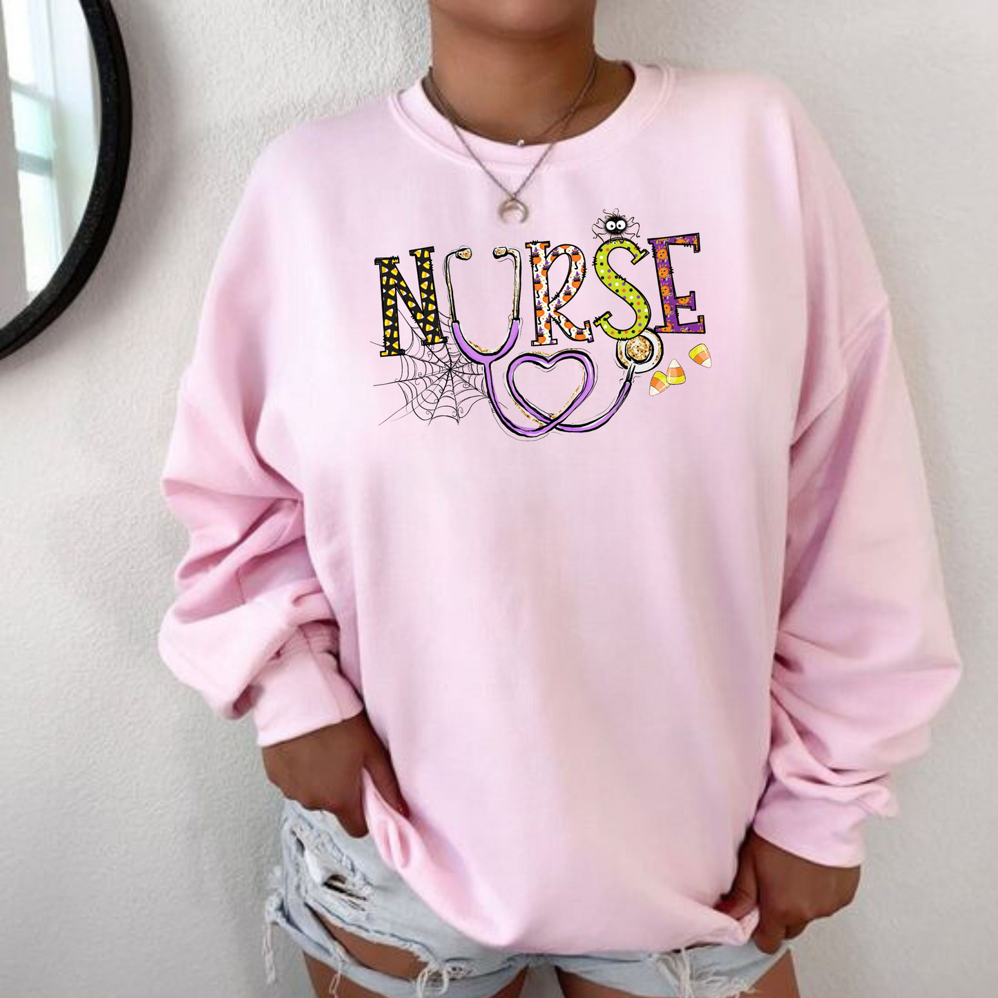 A cute Halloween Nurse Crewneck Sweatshirt, showcasing a fun and stylish design perfect for the spooky season. This nurse sweater is ideal for adding a festive touch to your nurse work outfit. Shop now and elevate your nurse clothes collection with this adorable nurse sweatshirt, the perfect Halloween shirt for nurses.