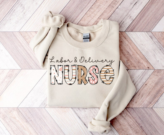 Make a statement with our Labor and Delivery Nurse Crewneck Sweatshirt.  This cute nurse sweater is perfect for RNs and registered nurses working in labor and delivery (L&D). Elevate your nurse work outfit with this stylish and comfortable OB Nurse sweatshirt. Shop now and add this unique nurse sweatshirt to your collection of nurse clothes. Get ready to rock your nurse outfit for work as an L&D nurse!