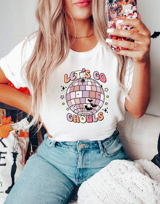 A cute and retro Halloween shirt featuring the text 'Let's Go Ghouls' with a playful ghost design, perfect for Halloween festivities and spooky fun.