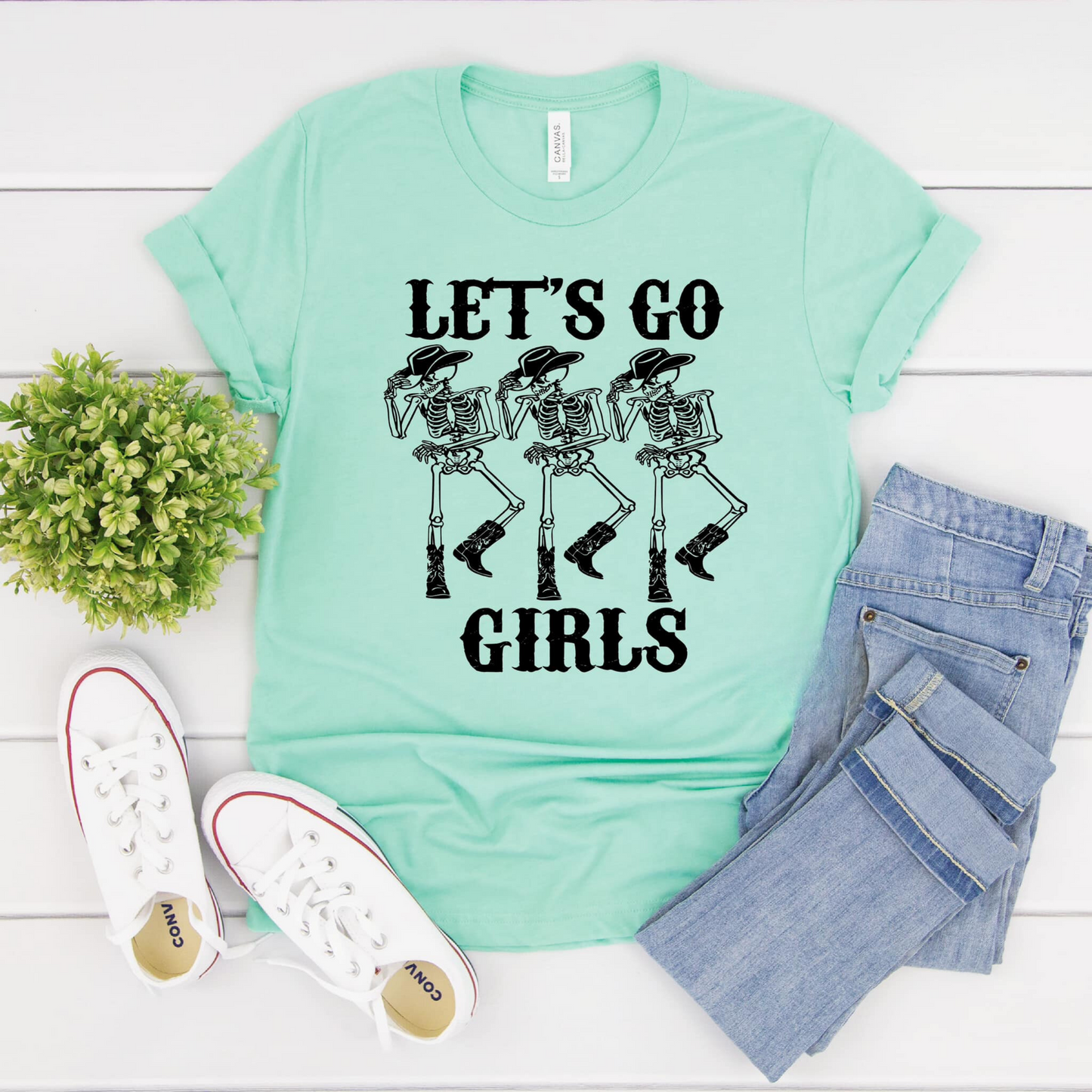 Skeleton cowgirl shirt for women with the text 'Let's Go Girls' - a humorous and stylish addition to your summer cowgirl outfit.