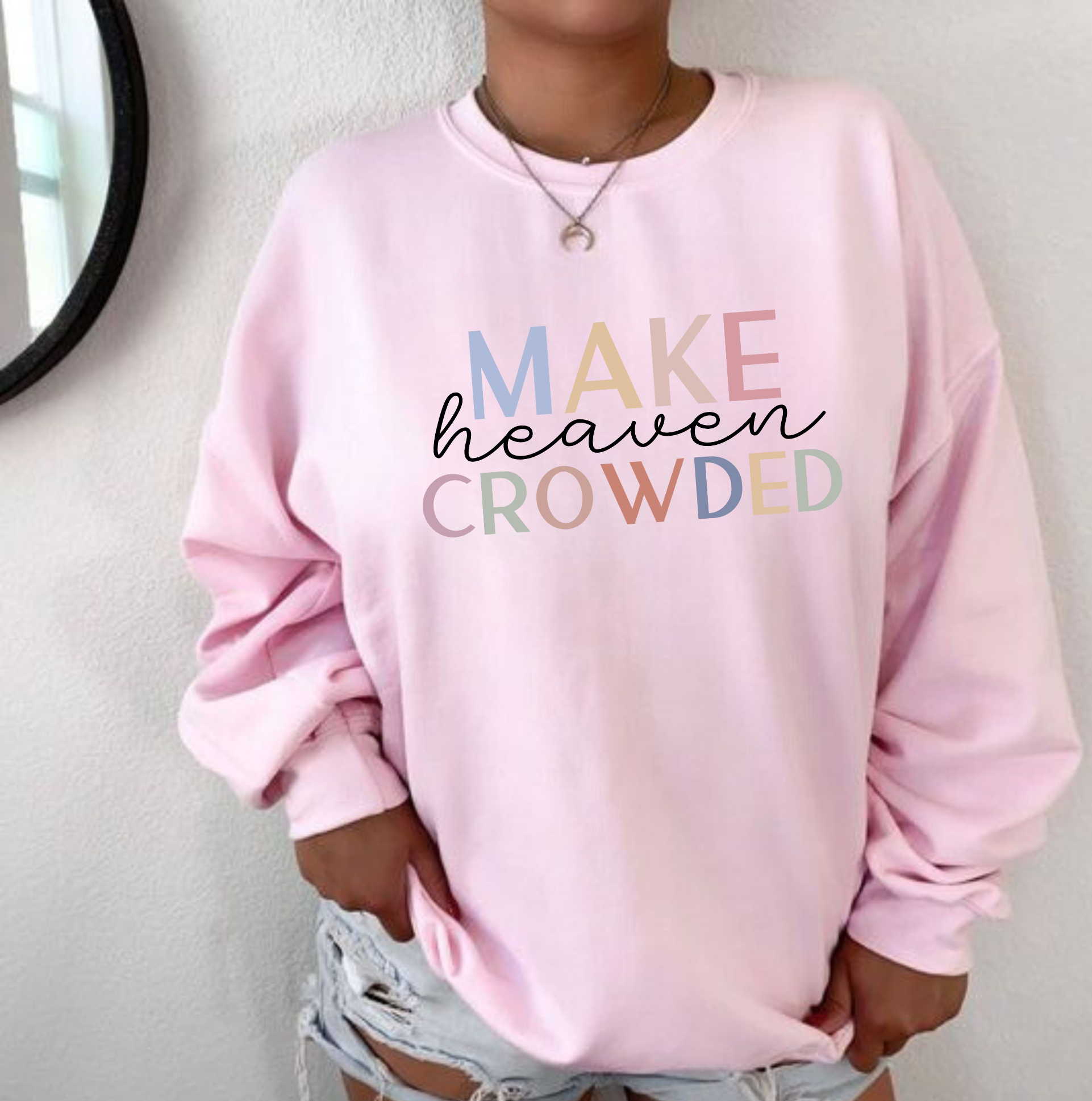 "Make heaven crowded" Christian crewneck sweatshirt featuring bold text and heavenly design elements.