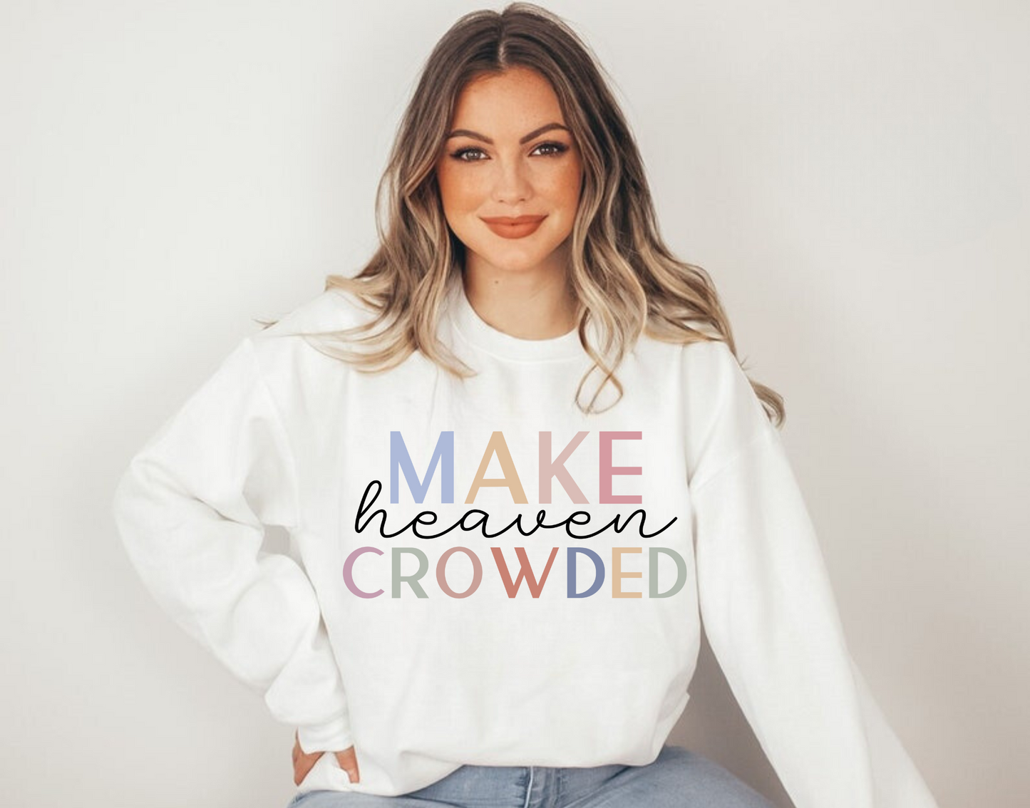 "Make heaven crowded" Christian crewneck sweatshirt featuring bold text and heavenly design elements.