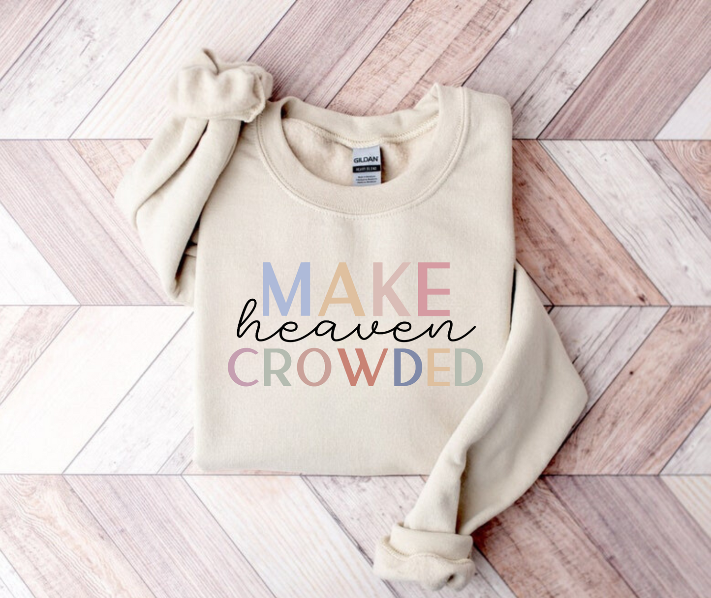 "Make heaven crowded" Christian crewneck sweatshirt featuring bold text and heavenly design elements.