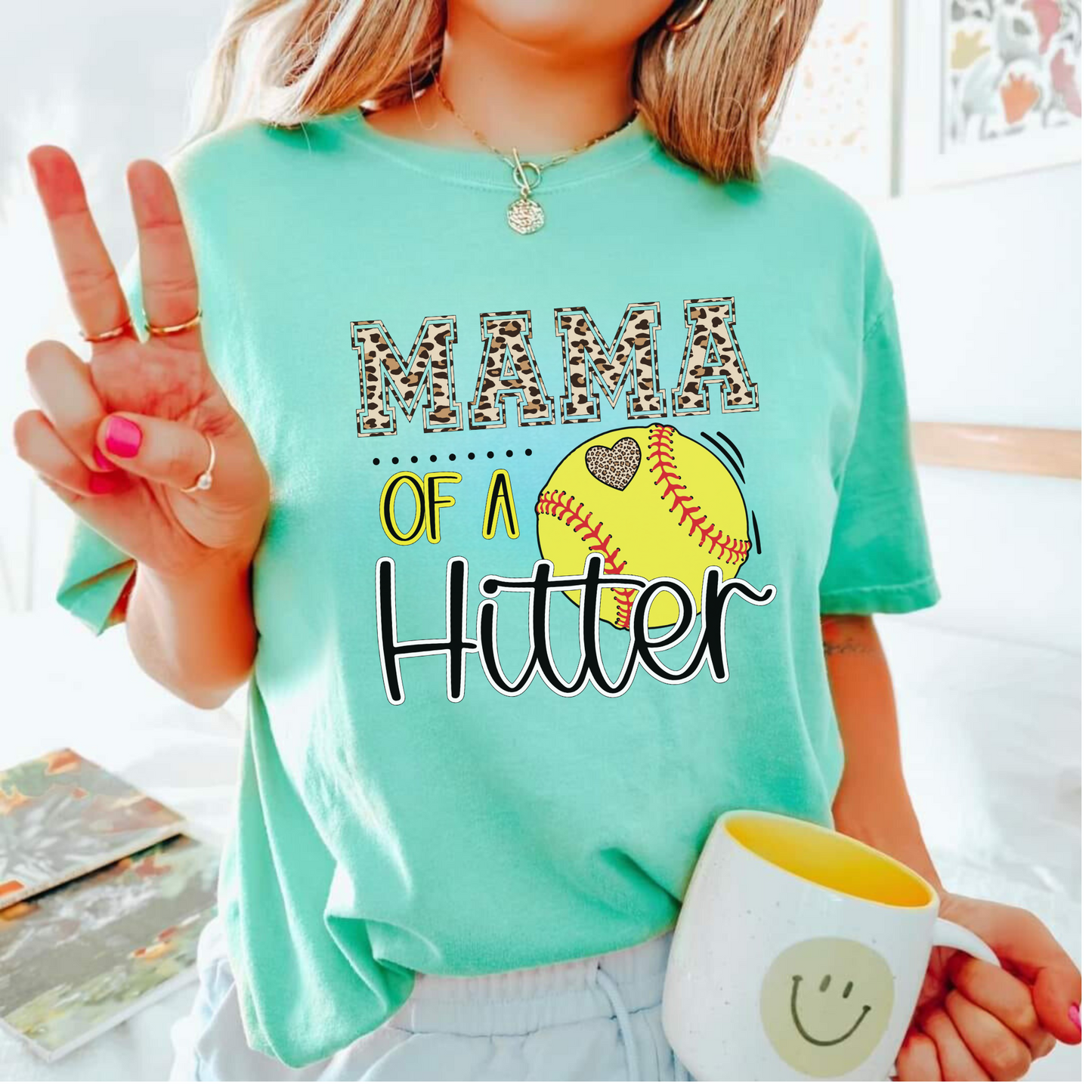 Mama of a Hitter, a trendy softball mom shirt that is perfect for softball game day!