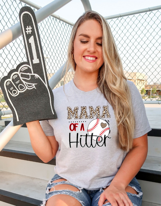  Baseball Mom Shirt with the phrase 'Mom of a Hitter' in trendy leopard print. A cute and stylish graphic tee for baseball game days and proud baseball moms. Perfect for showcasing team spirit and fashionable support.