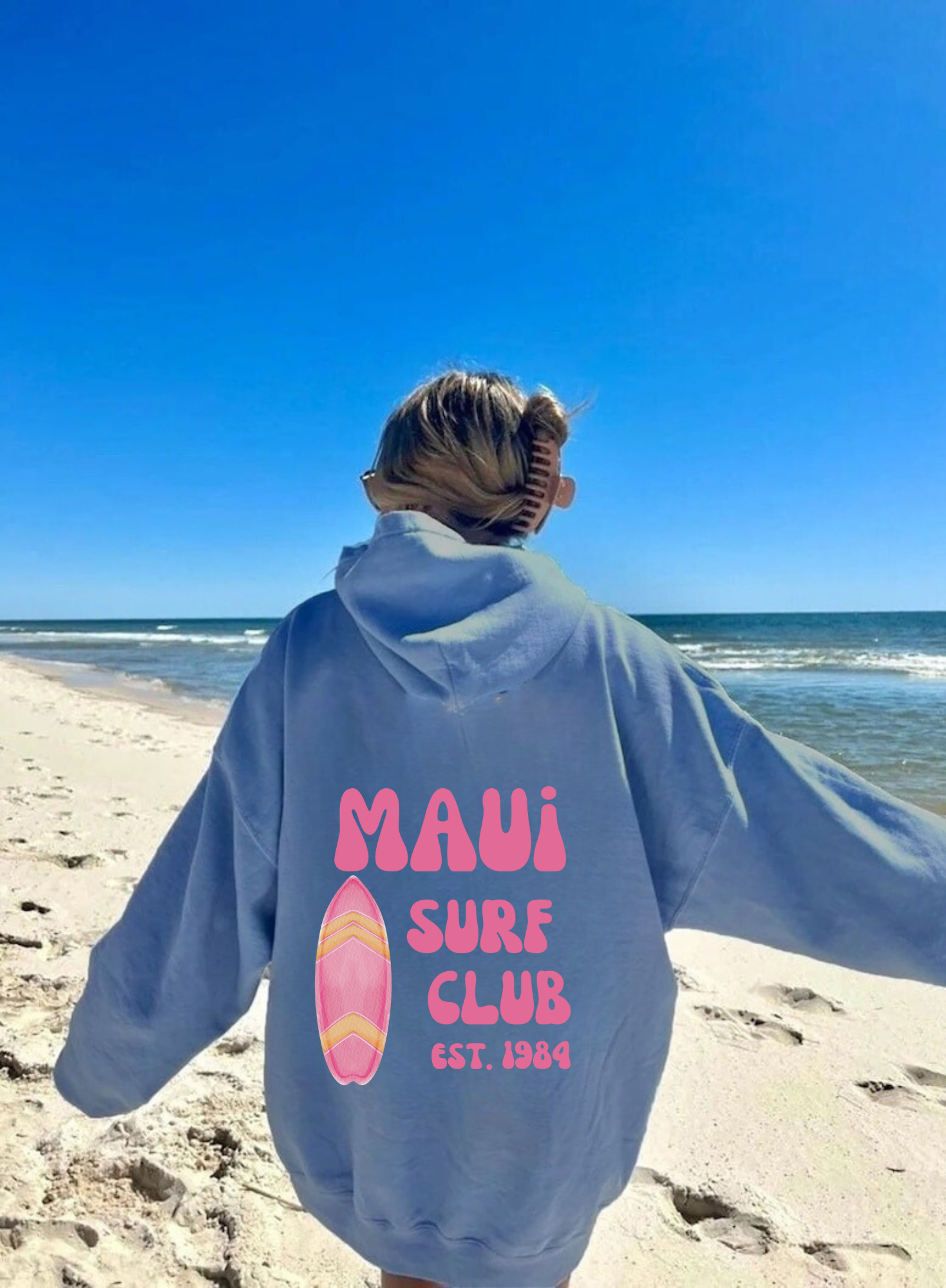  Oversized beach hoodie sweatshirt for women with "Maui Surf Club" on the back, perfect for a summer beach day outfit.