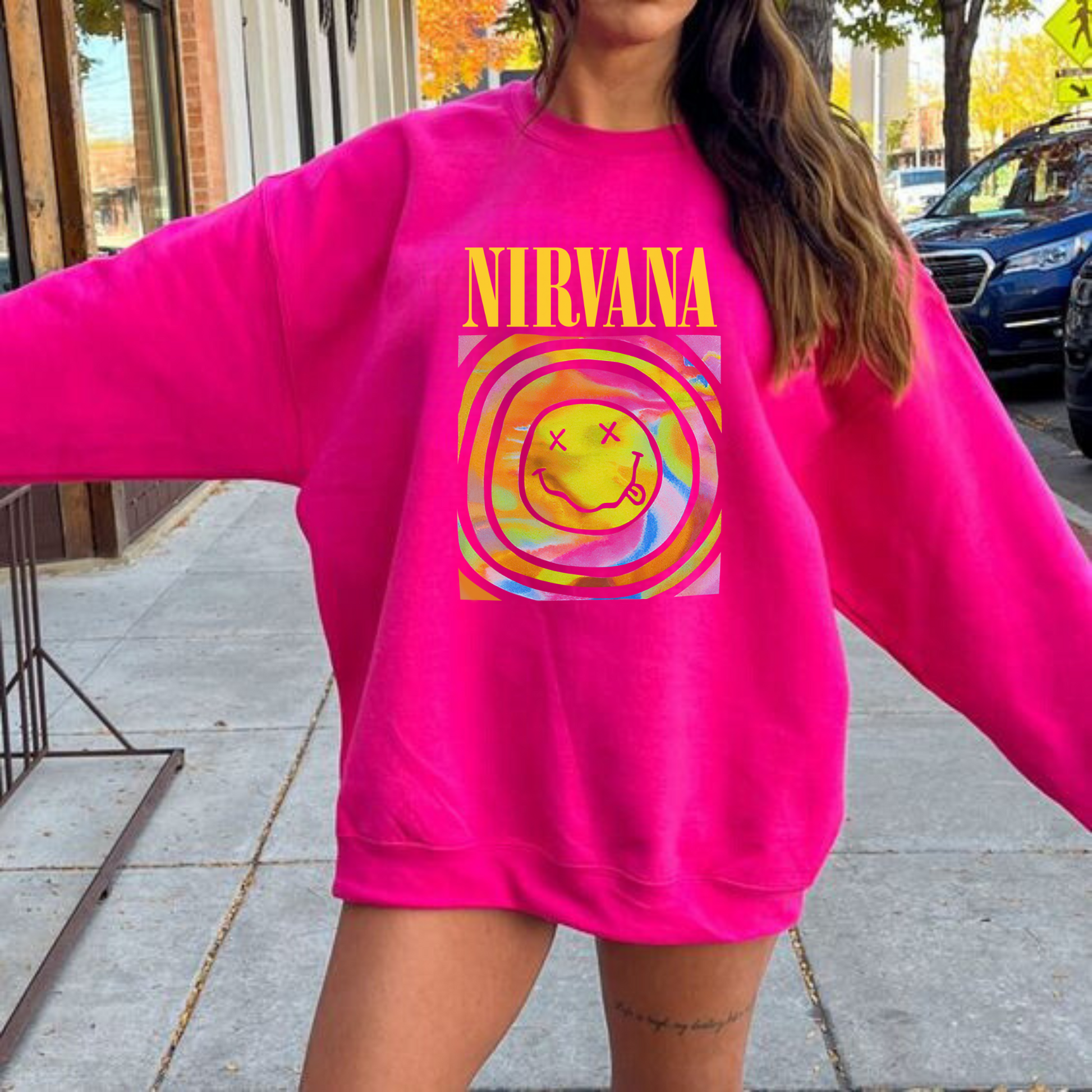 A Pink Preppy Nirvana Crewneck Sweatshirt, adding a stylish twist to casual comfort with a trendy y2k graphic. The oversized sweatshirt features a cute and unique preppy take on the iconic band sweatshirt.