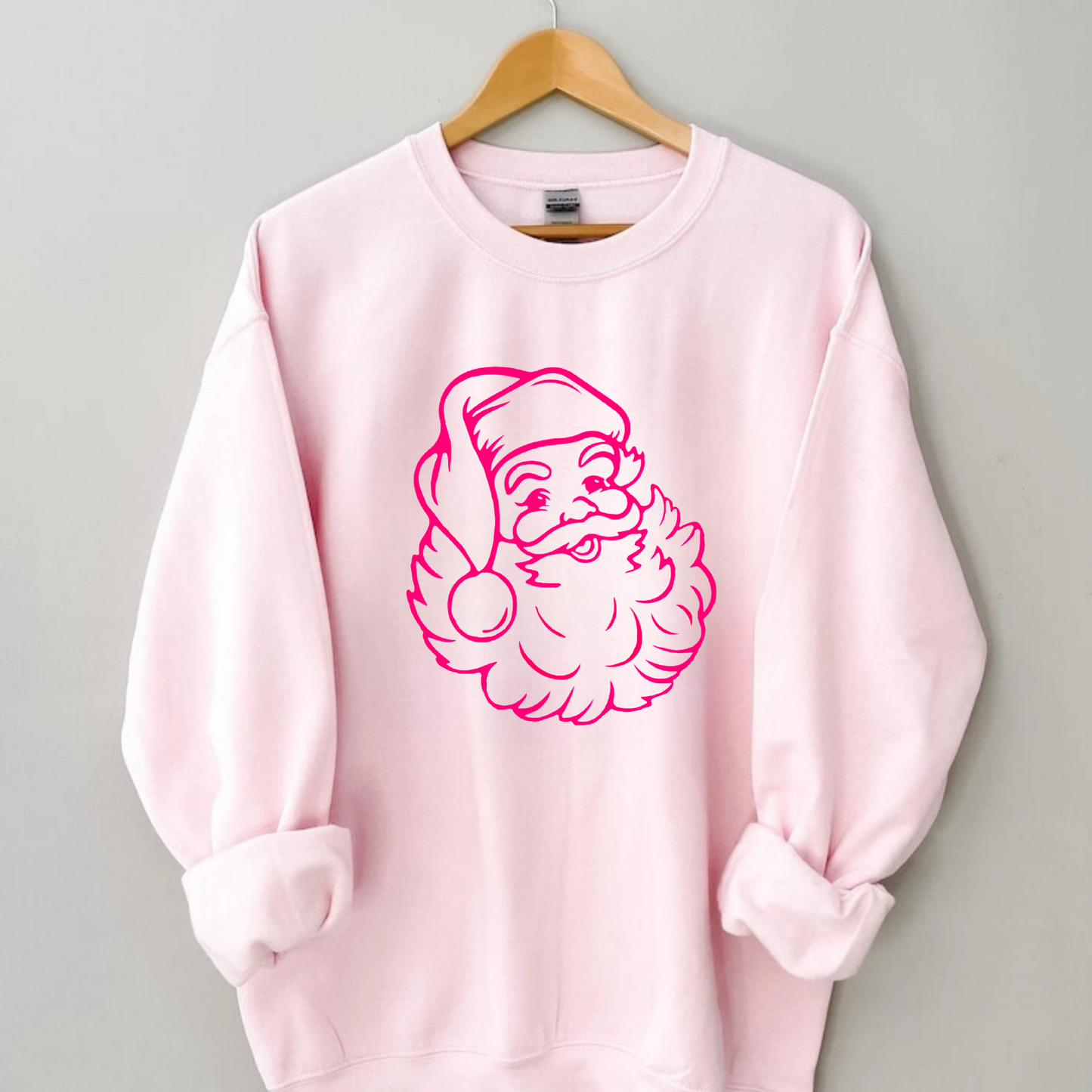 Cozy pink crewneck sweatshirt with preppy Santa design, suitable for holiday events and everyday winter style.