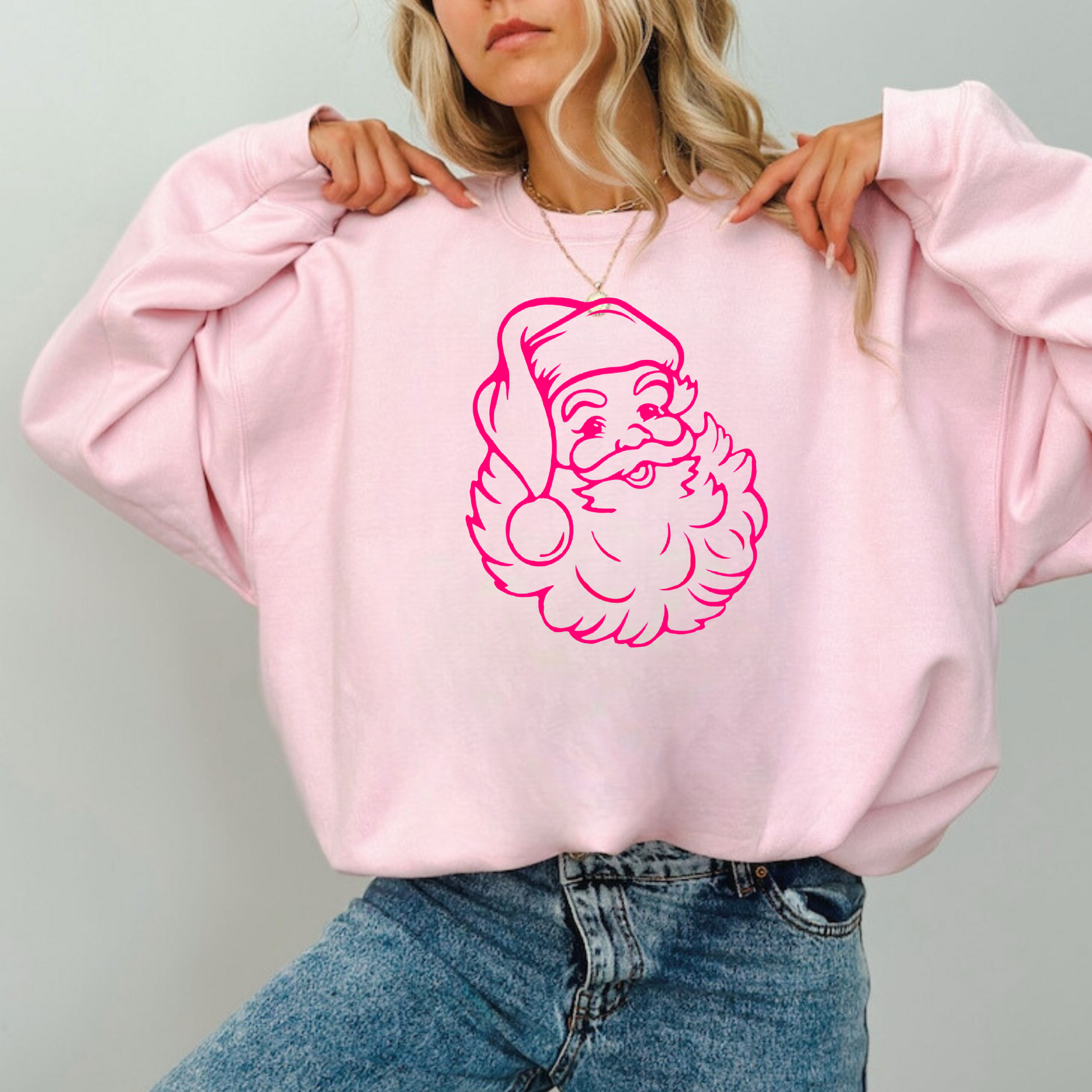 Cozy pink crewneck sweatshirt with preppy Santa design, suitable for holiday events and everyday winter style.