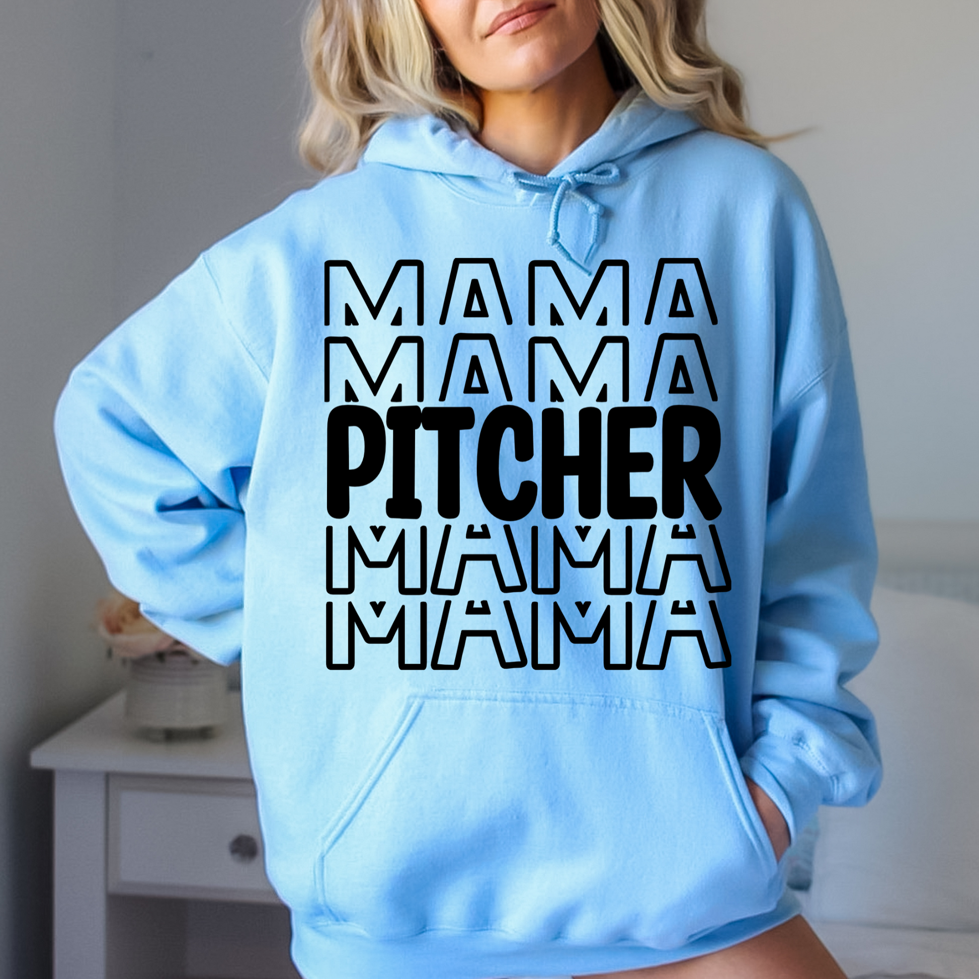 A comfortable and stylish baseball mom hoodie sweatshirt with the words 'Pitcher Mama'. This baseball mom outfit is perfect for game day at the baseball game, featuring a cozy design that celebrates the role of a dedicated catcher mom.