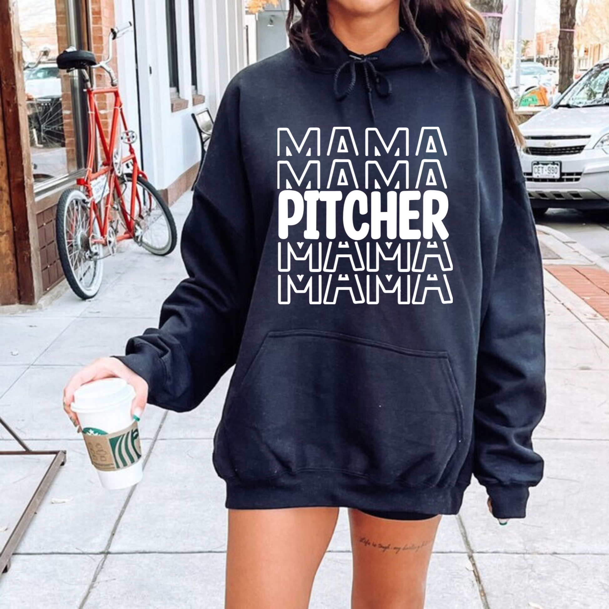 A comfortable and stylish baseball mom hoodie sweatshirt with the words 'Pitcher Mama'. This baseball mom outfit is perfect for game day at the baseball game, featuring a cozy design that celebrates the role of a dedicated catcher mom.