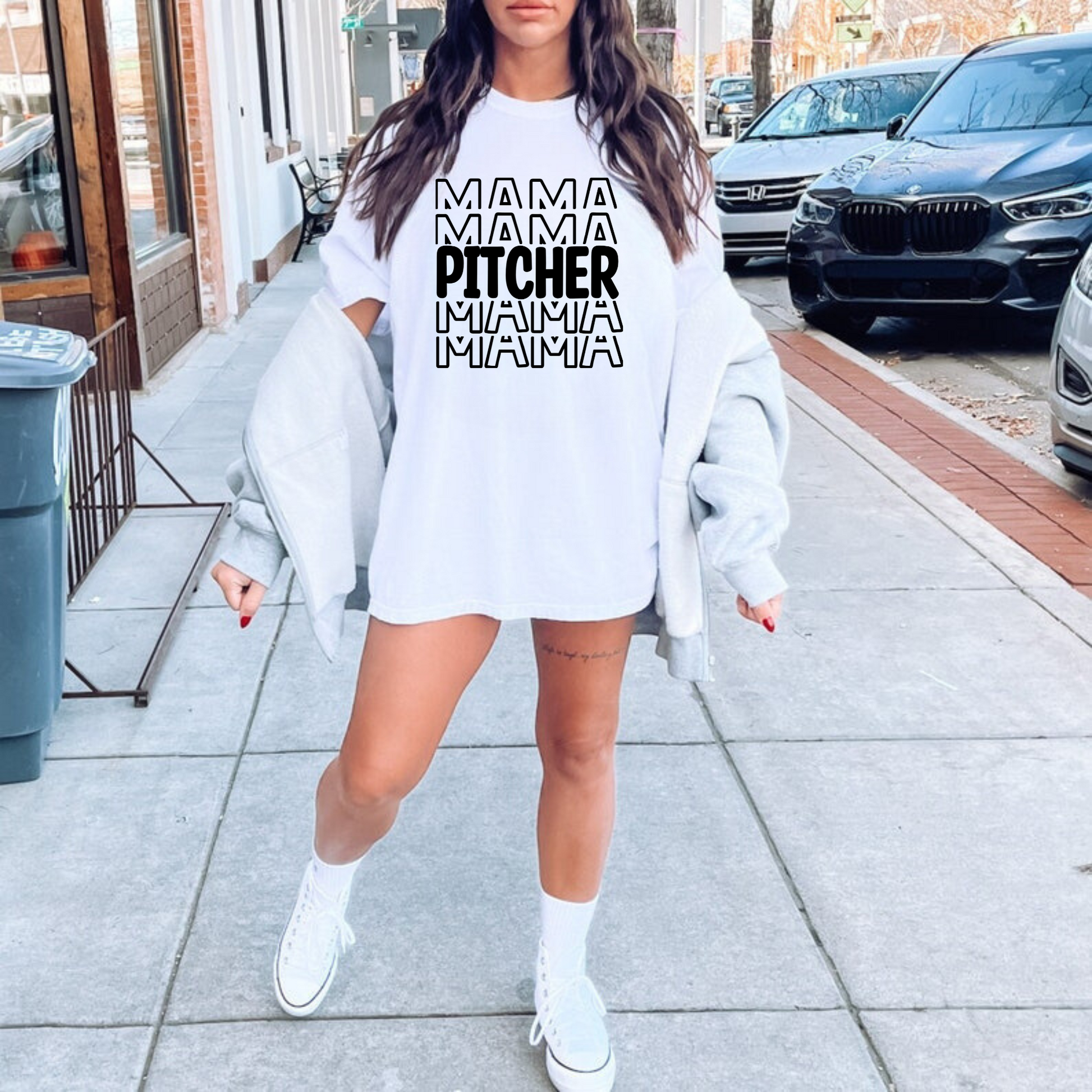 A stylish baseball mom shirt with the text 'Pitcher Mama', perfect for game day and showing off your love for baseball. The shirt features a comfortable fit and is a great choice for a mom outfit at the baseball game.