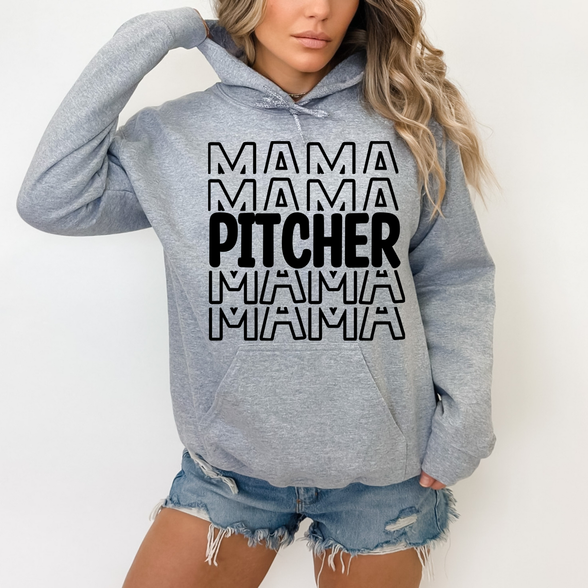 A comfortable and stylish baseball mom hoodie sweatshirt with the words 'Pitcher Mama'. This baseball mom outfit is perfect for game day at the baseball game, featuring a cozy design that celebrates the role of a dedicated catcher mom.