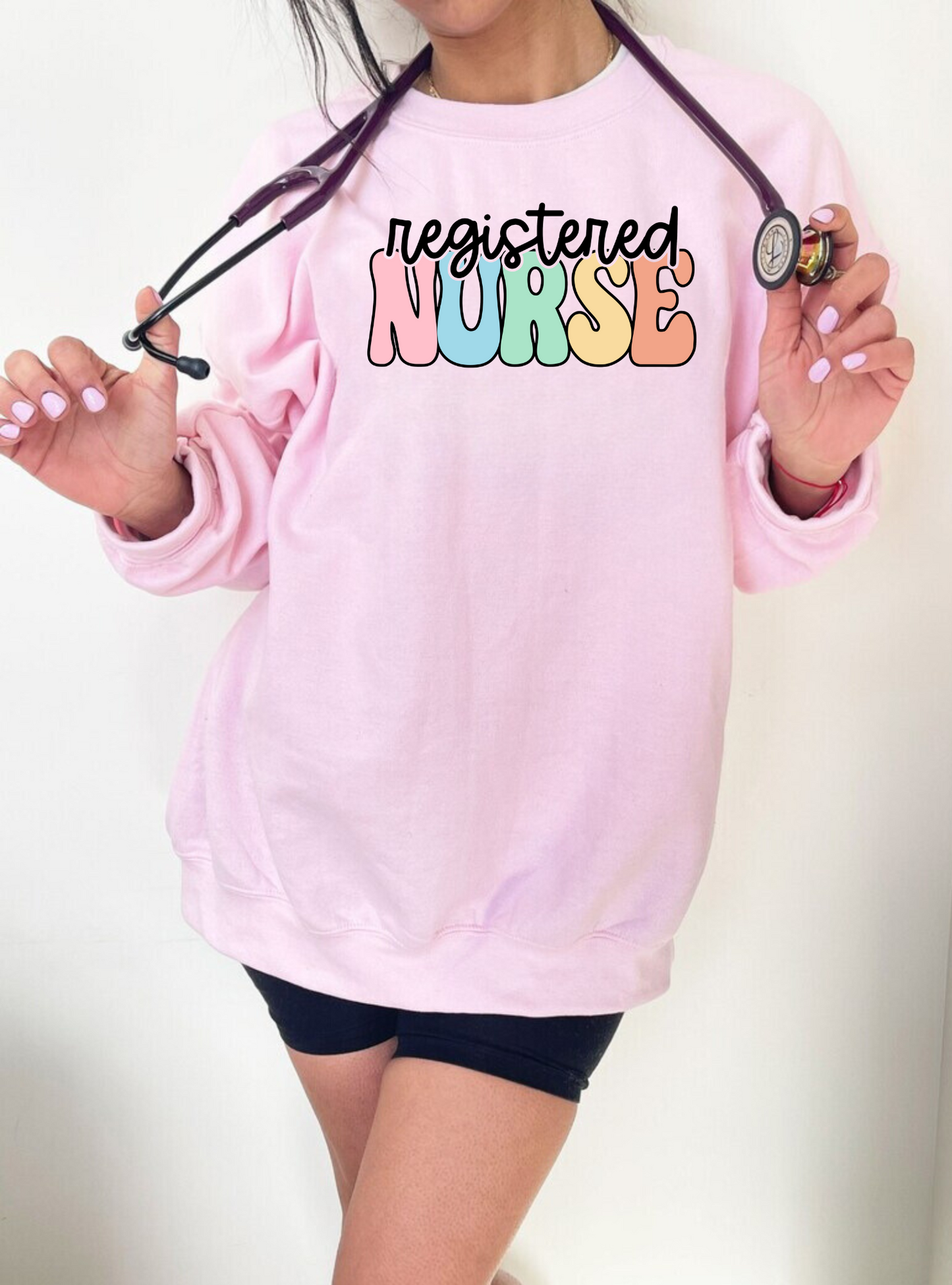 Retro Rainbow Registered Nurse Crewneck Sweatshirt - Cute and cozy nurse apparel with a vintage-inspired font in rainbow colors