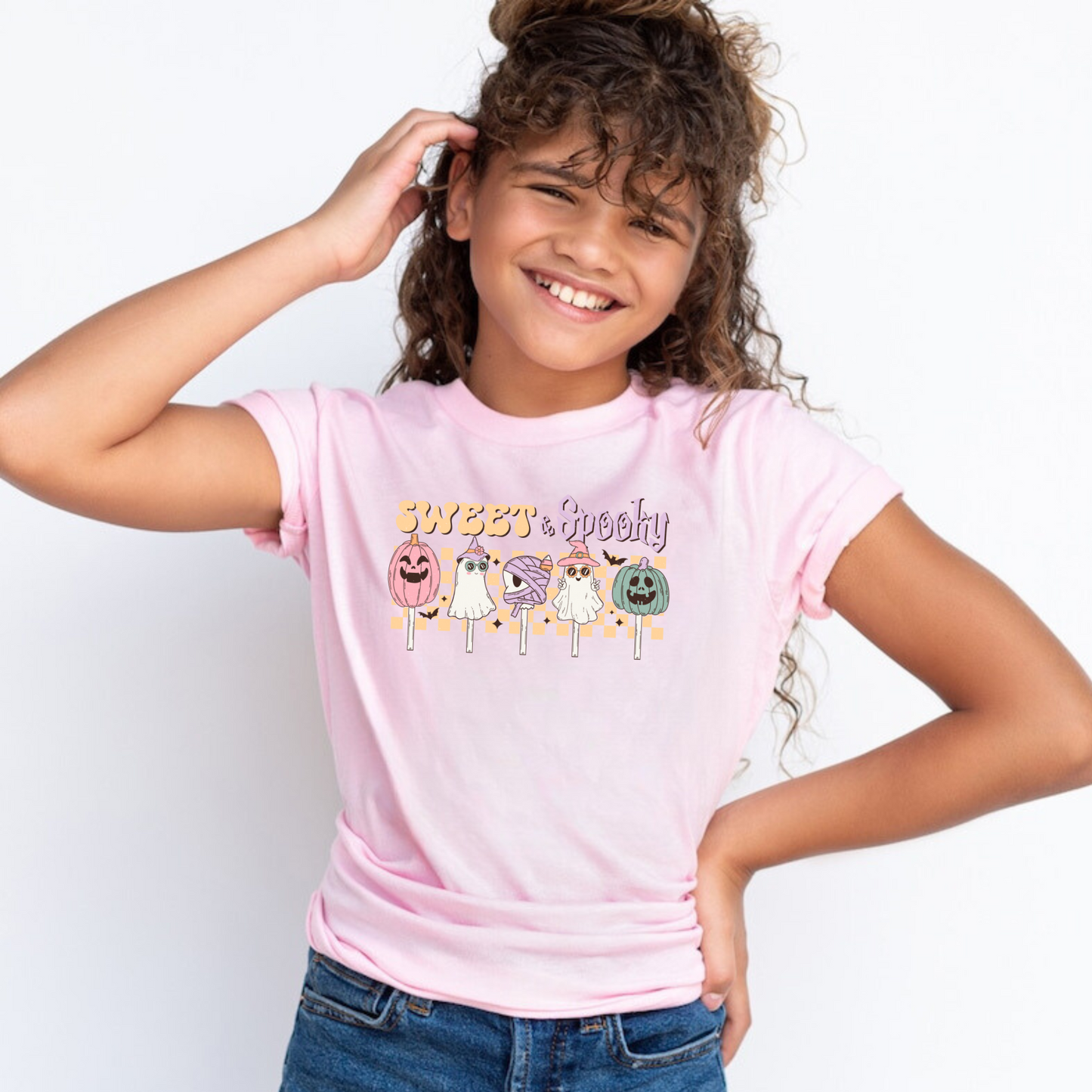 An adorable Halloween shirt for girls with the phrase ',Sweet and Spooky featuring a preppy and playful design. The shirt adds a unique touch to her Halloween outfit, embodying the essence of cute Halloween fun.