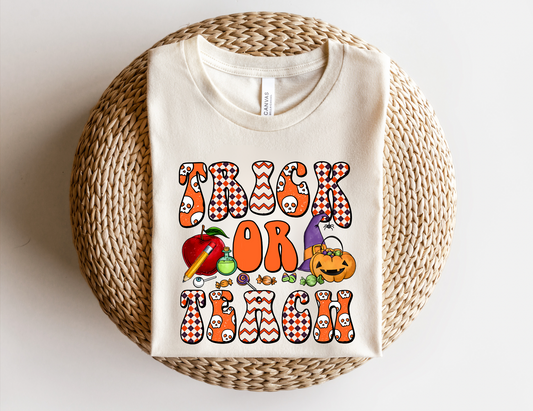 A 'Trick or Teach' Halloween Shirt, adding a touch of spooky charm to teacher style. This cozy and cute fall outfit celebrates the autumn season with a playful and fashionable vibe, suitable for Halloween costume ideas or standalone wear.