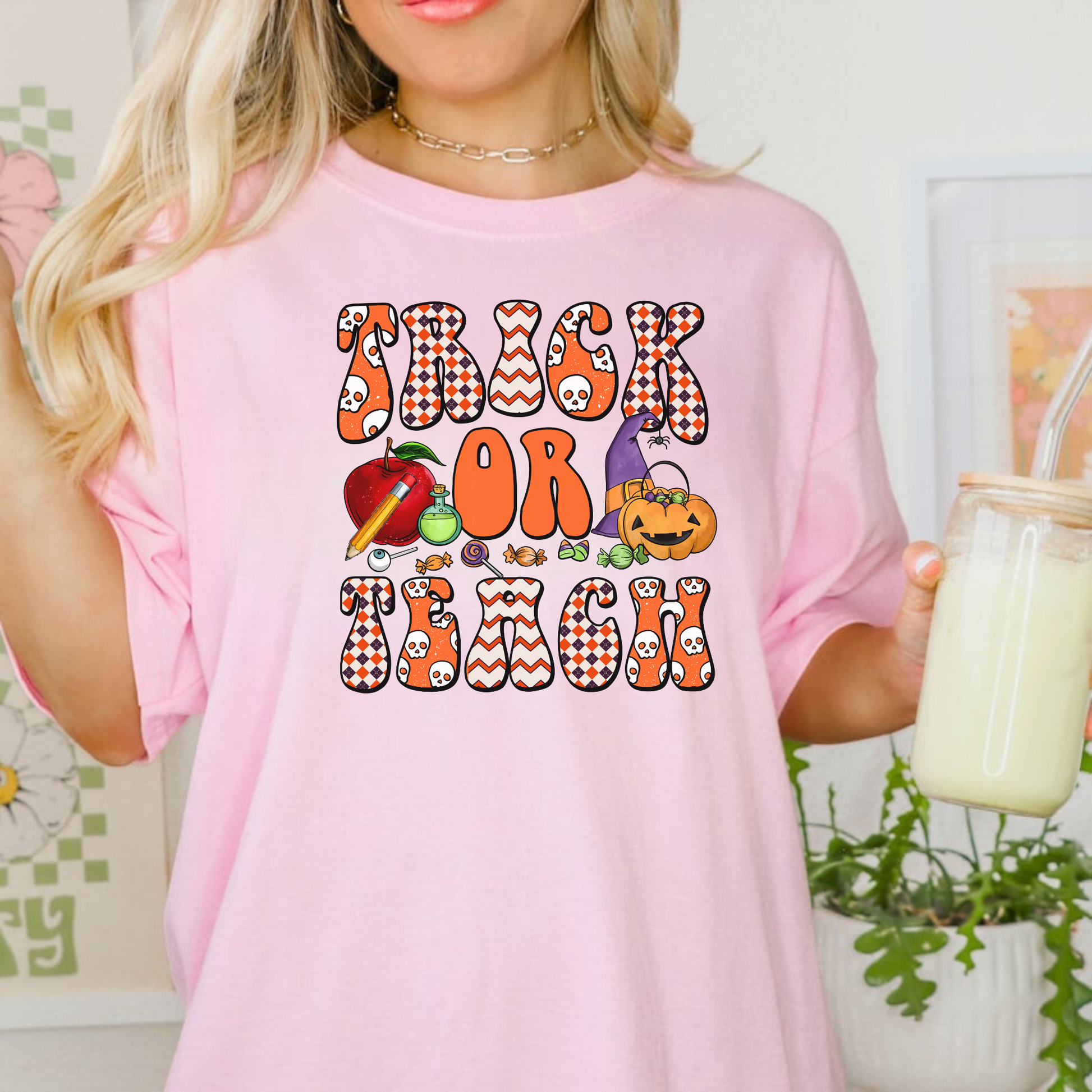 A 'Trick or Teach' Halloween Shirt, adding a touch of spooky charm to teacher style. This cozy and cute fall outfit celebrates the autumn season with a playful and fashionable vibe, suitable for Halloween costume ideas or standalone wear.