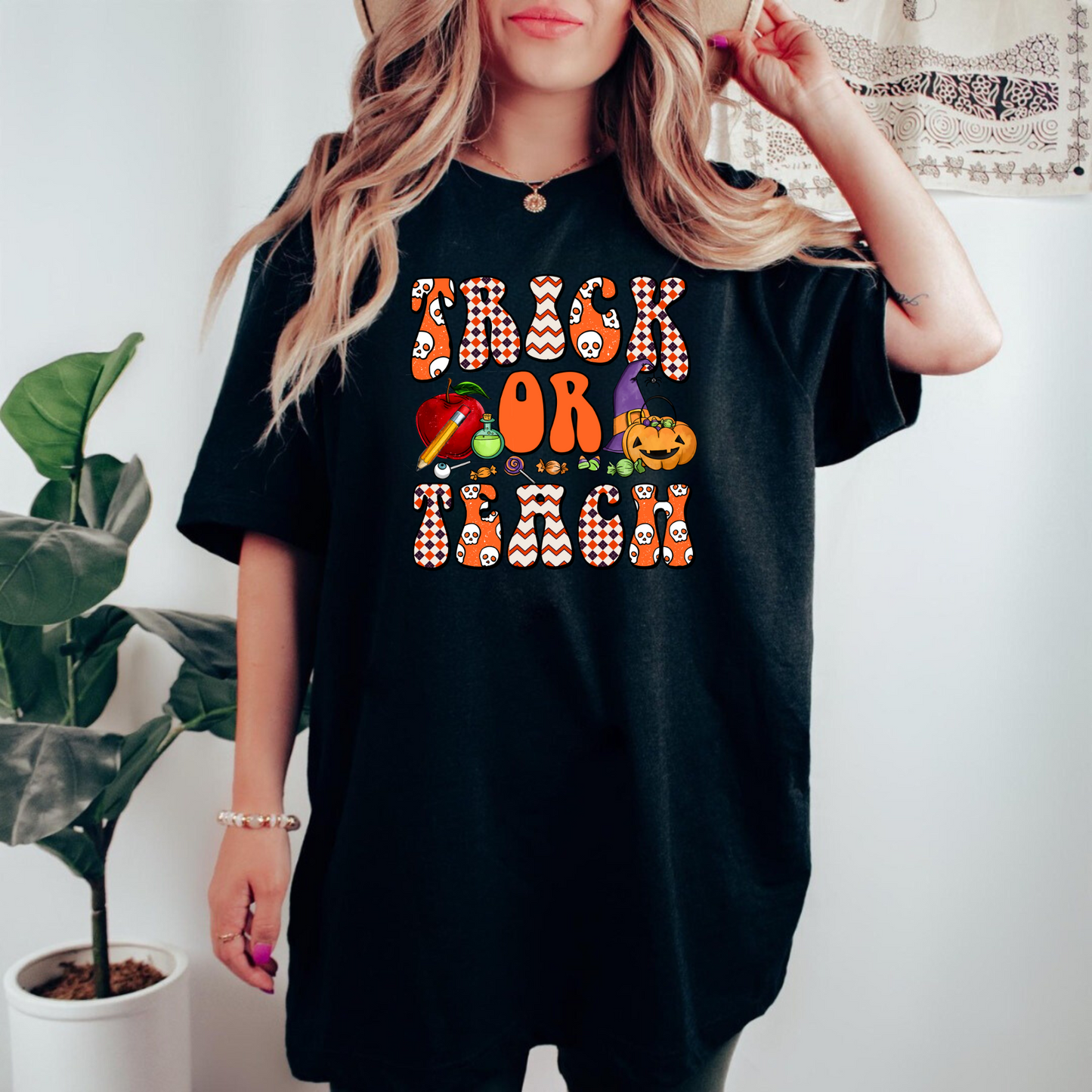 A 'Trick or Teach' Halloween Shirt, adding a touch of spooky charm to teacher style. This cozy and cute fall outfit celebrates the autumn season with a playful and fashionable vibe, suitable for Halloween costume ideas or standalone wear.