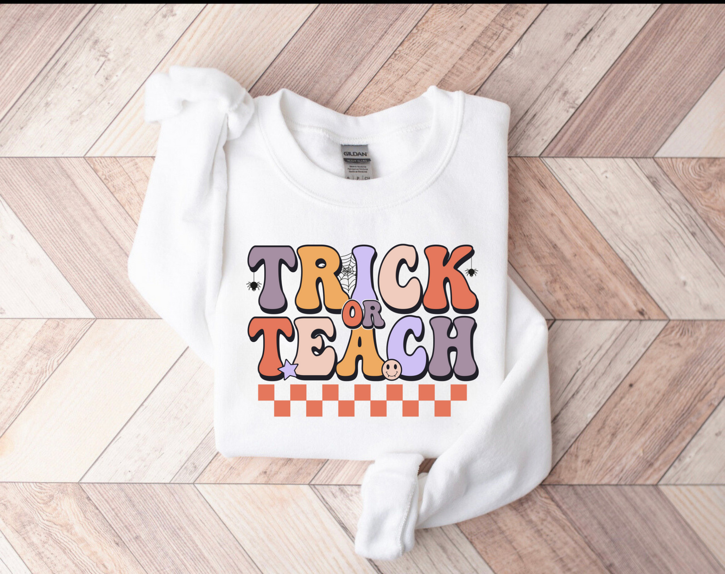 "Trick or Teach" Halloween teacher sweatshirt with a fun Halloween-themed design.