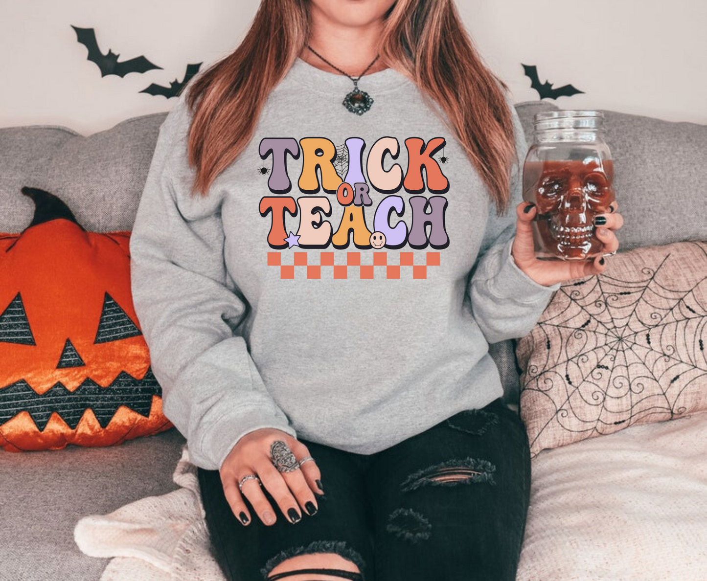 "Trick or Teach" Halloween teacher sweatshirt with a fun Halloween-themed design.