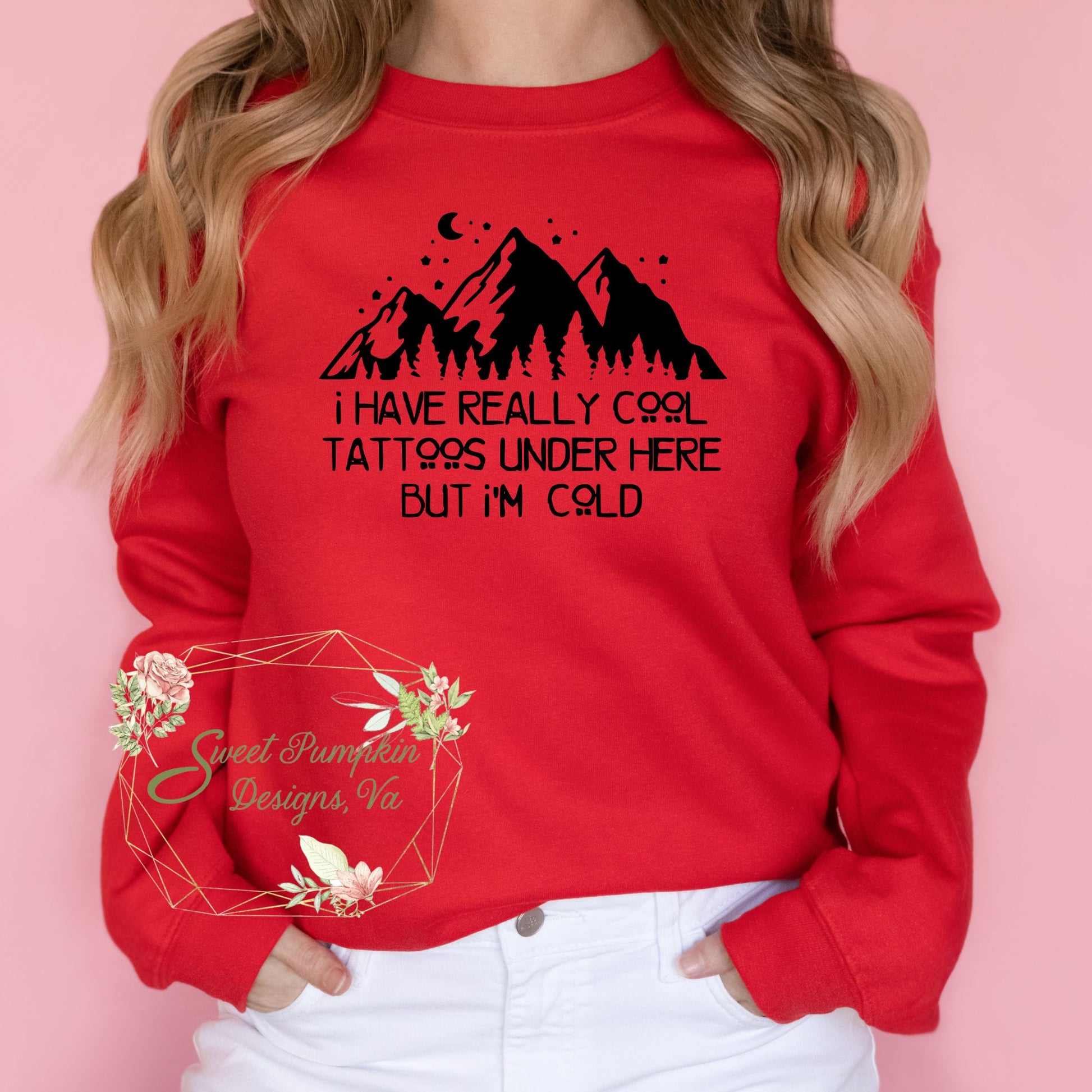 A trendy crewneck sweatshirt with a humorous graphic that reads 'I have really cool tattoos under here but I'm cold'. The graphic features bold typography. The sweatshirt is made from a soft and comfortable cotton blend and features ribbed cuffs and hem. It has a regular fit and a crewneck design.